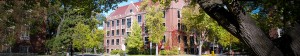 A campus building surrounded by trees.