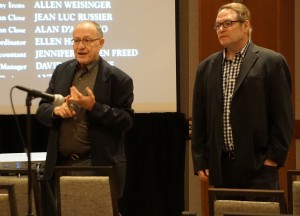 Alan Dershowitz standing in front of projector screen