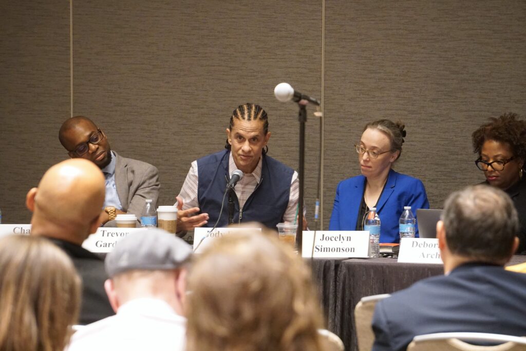 Panel sitting in front of an audience