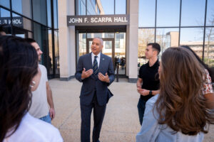 Mark Alexander speaking to a group outside of a building