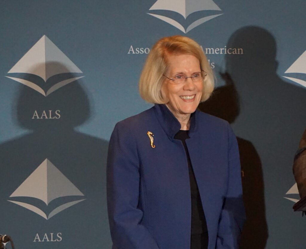 Judy Areen stands in front of an AALS backdrop at the Annual Meeting