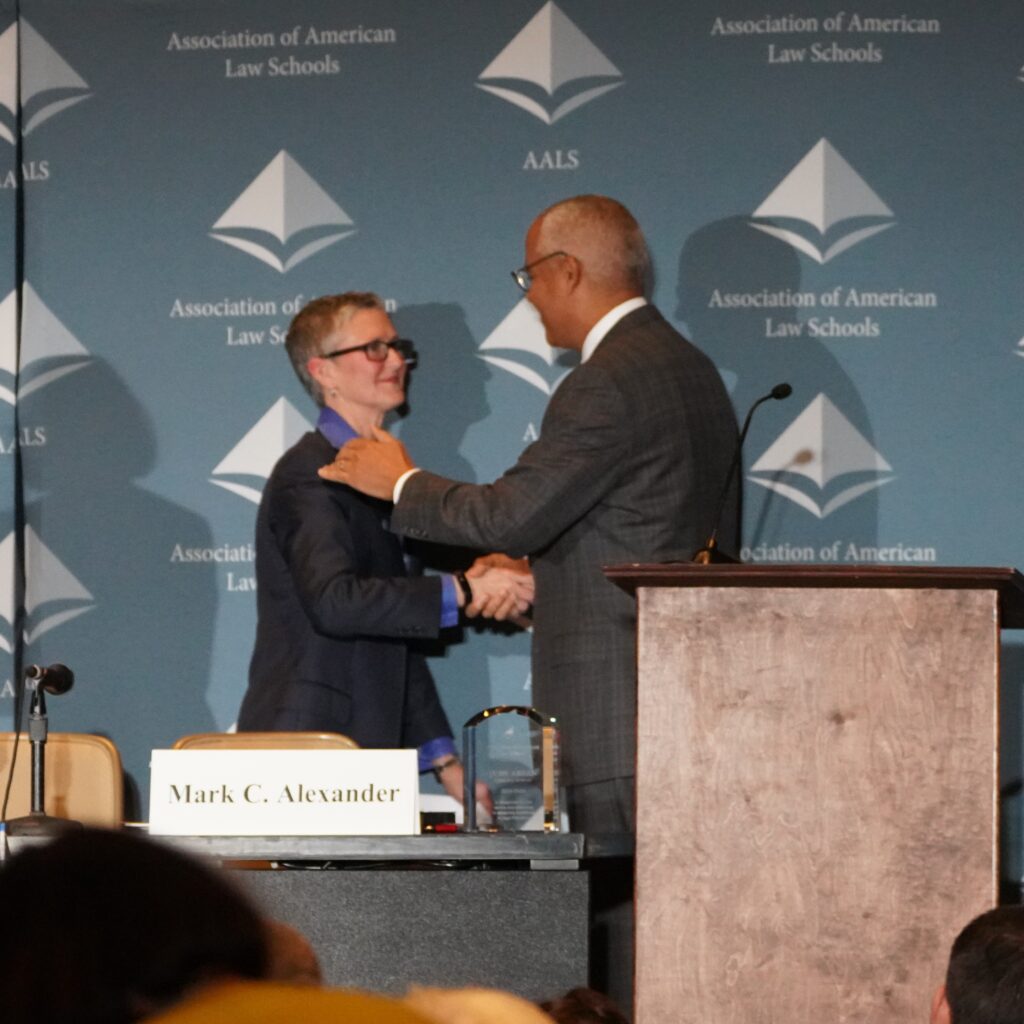 Melanie Wilson and Paul Marcus shaking hands