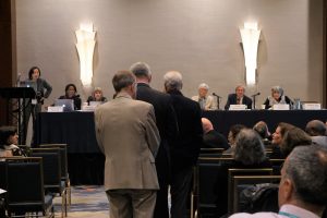 Audience members line up to pose questions during the discussion portion of the Hot Topic program on bar exam scores and new ABA pass standards.