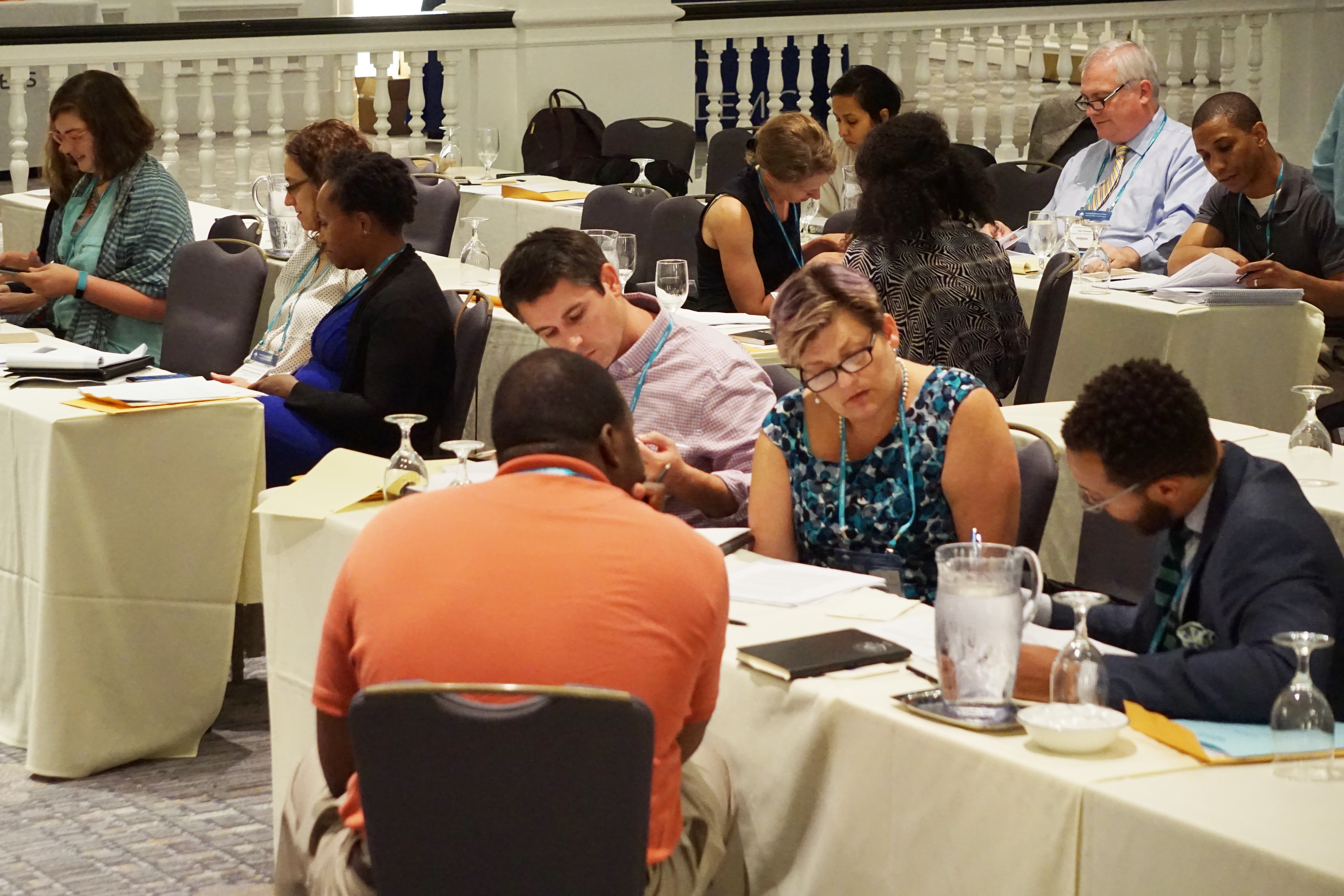 Attendees engage in small group discussions during a session