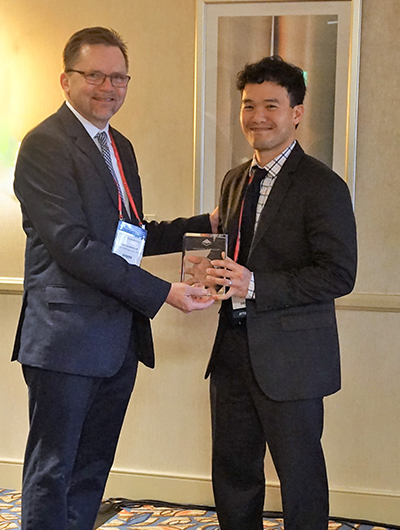 Kent Greenfield, (Boston College Law) presents the 2018 AALS Scholarly Papers Competition Award to Aaron Tang (UC Davis Law).